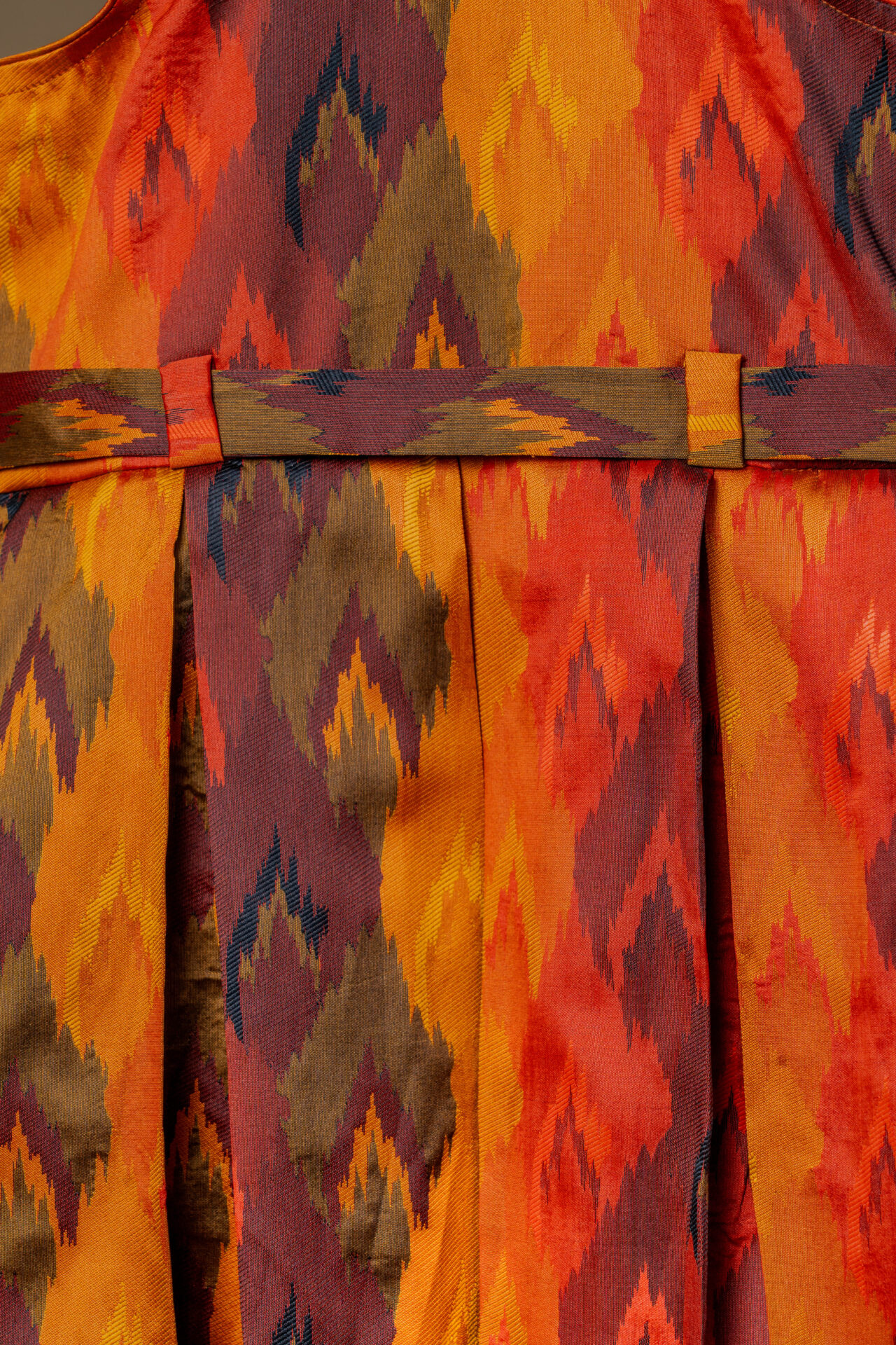 Vibrant Autumn Ikat Print Girl's Dress with Fixed Waist Belt and Pleated Skirt - Image 2