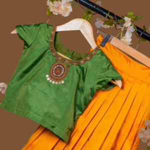 Traditional Green Silk Blouse with Coin and Bead Embellishment, Paired with Golden Yellow Pleated Skirt